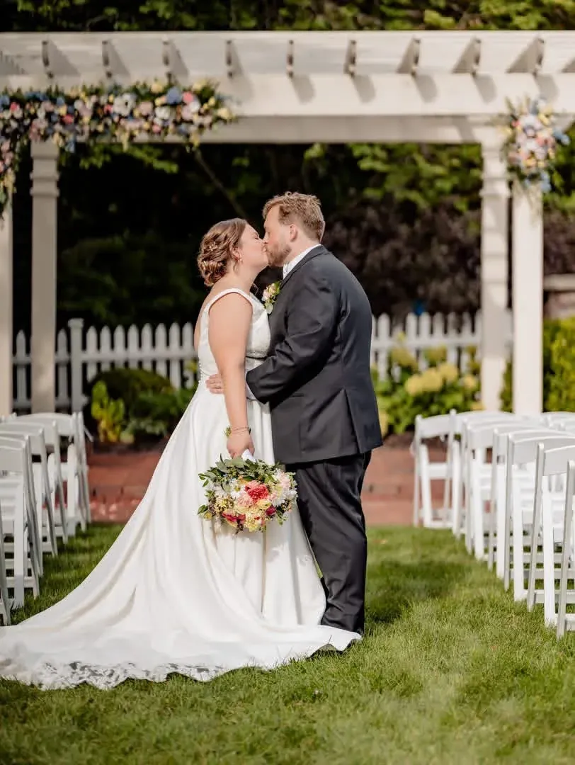 Newlyweds standing together in the garden after their ceremony
